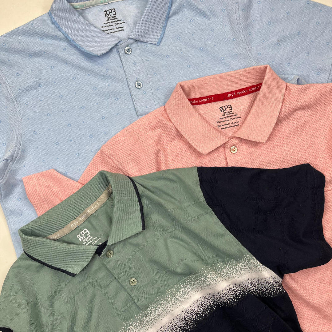 3 polos in all over print blue, popcorn texture peach and self jacquard design green lay flat on a cream background