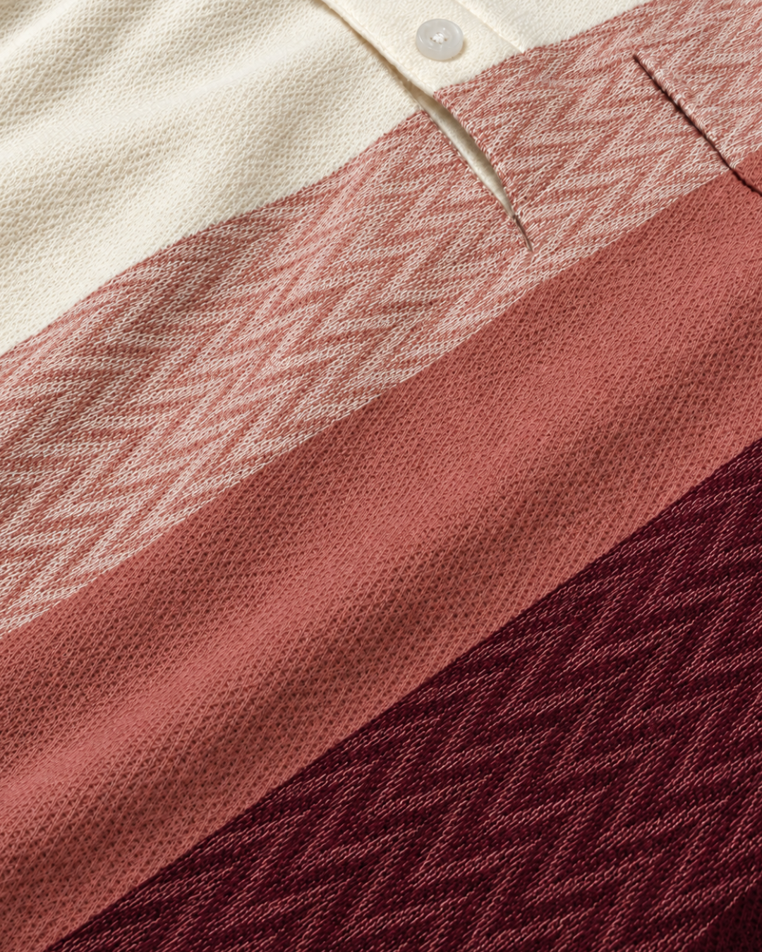 Close-up of The Ombre Stripes Designer Polo fabric in Poppins Red, showing jacquard chevron knit and piqué-style stripes