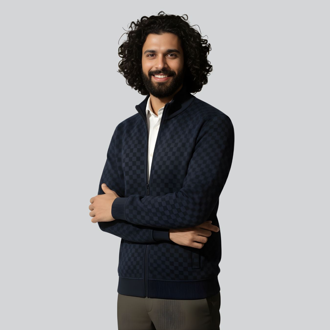 Man wearing a dark quilted jacket with a light gray background