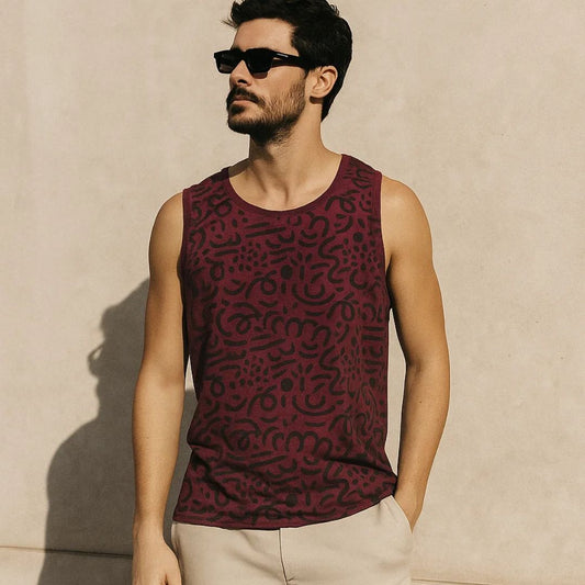 Man wearing a patterned sleeveless shirt against a beige wall
