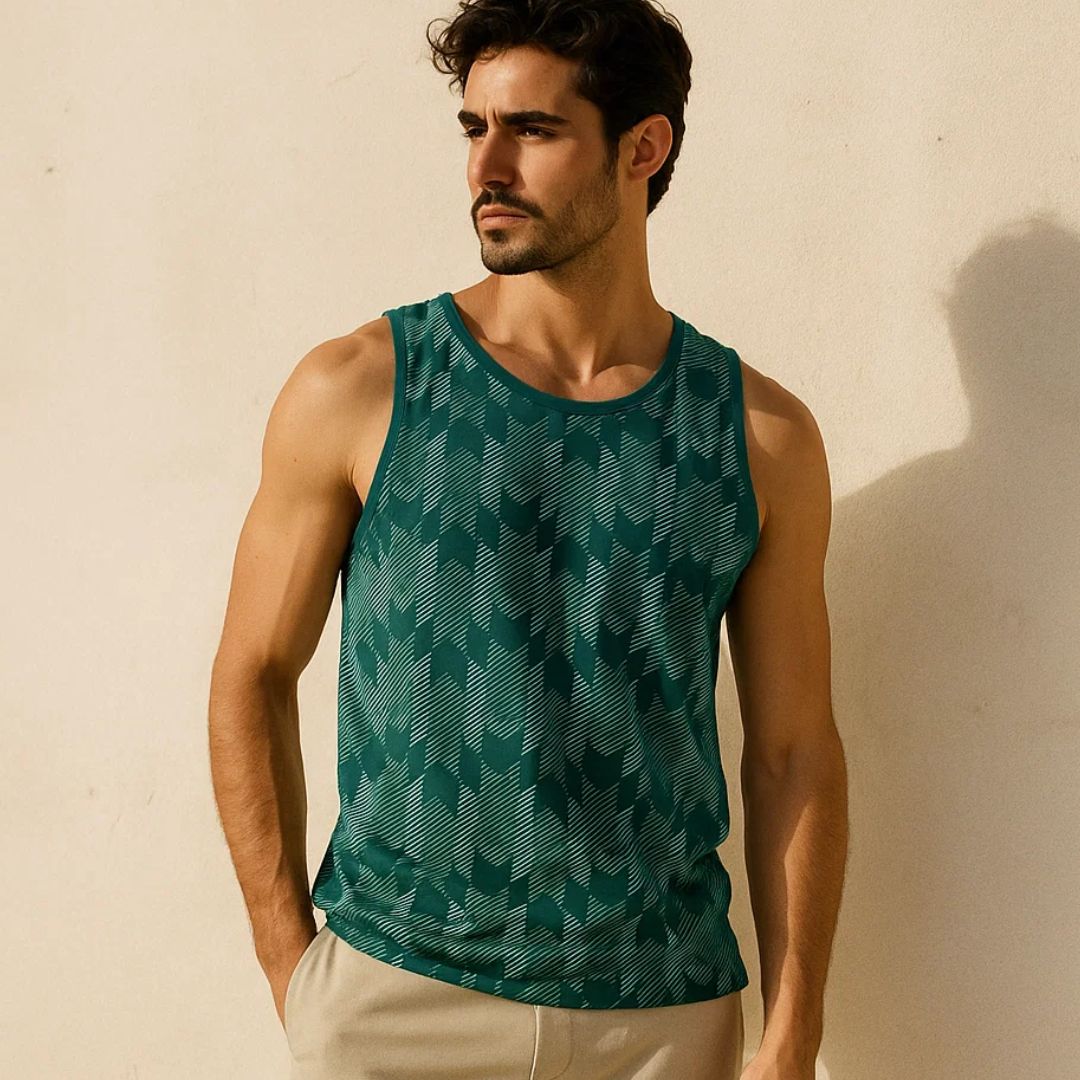 Man wearing a green patterned tank top against a beige background