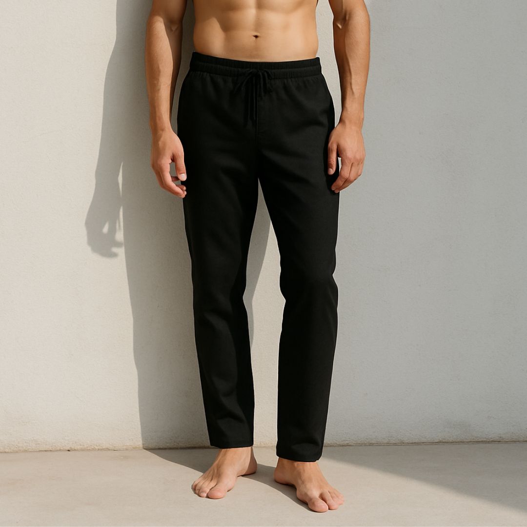 Person wearing black pants against a neutral background