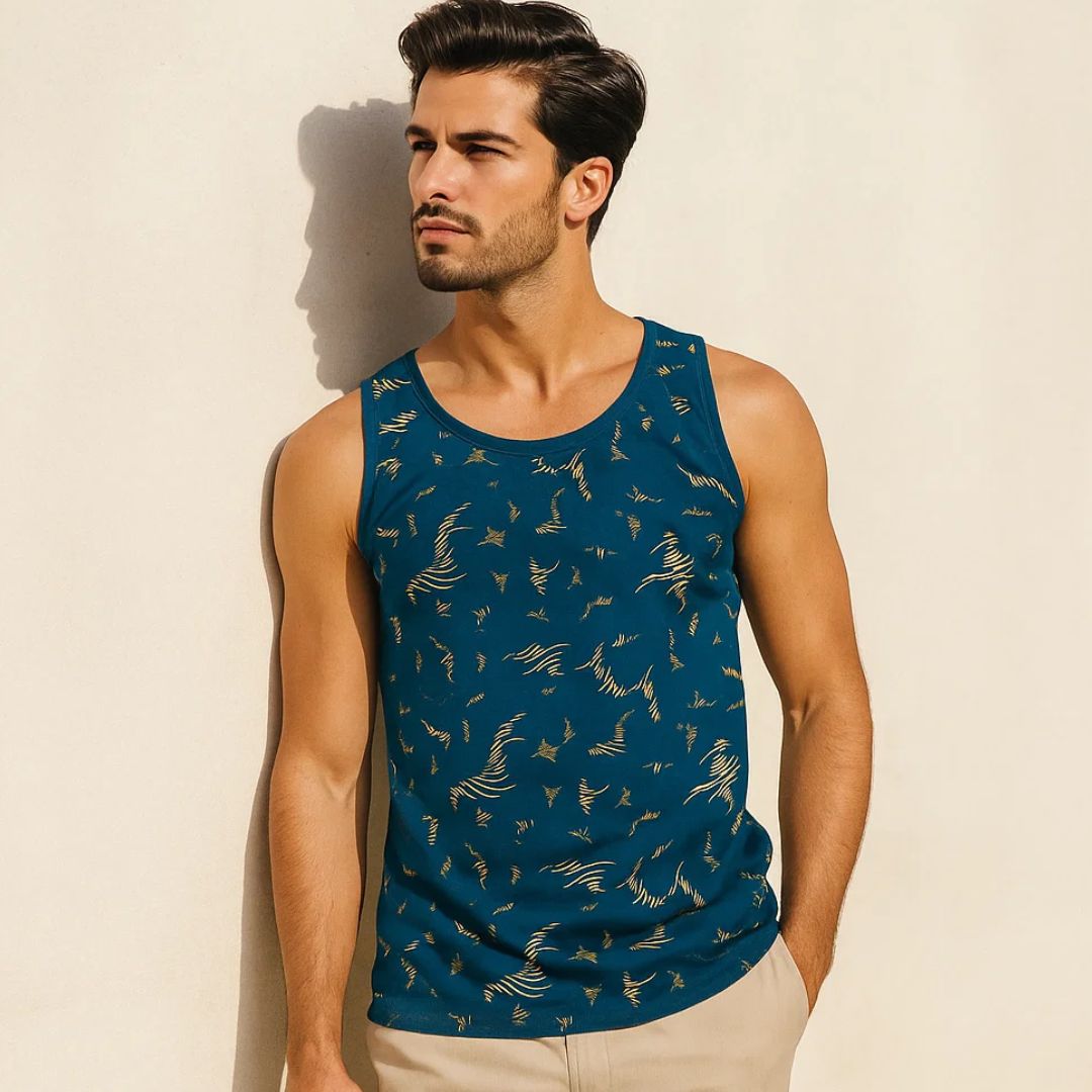 Man wearing a blue tank top with a pattern against a beige background