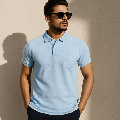 Man wearing a light blue polo shirt against a beige background