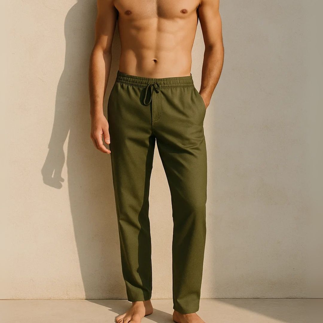 Man wearing olive green pants against a beige wall