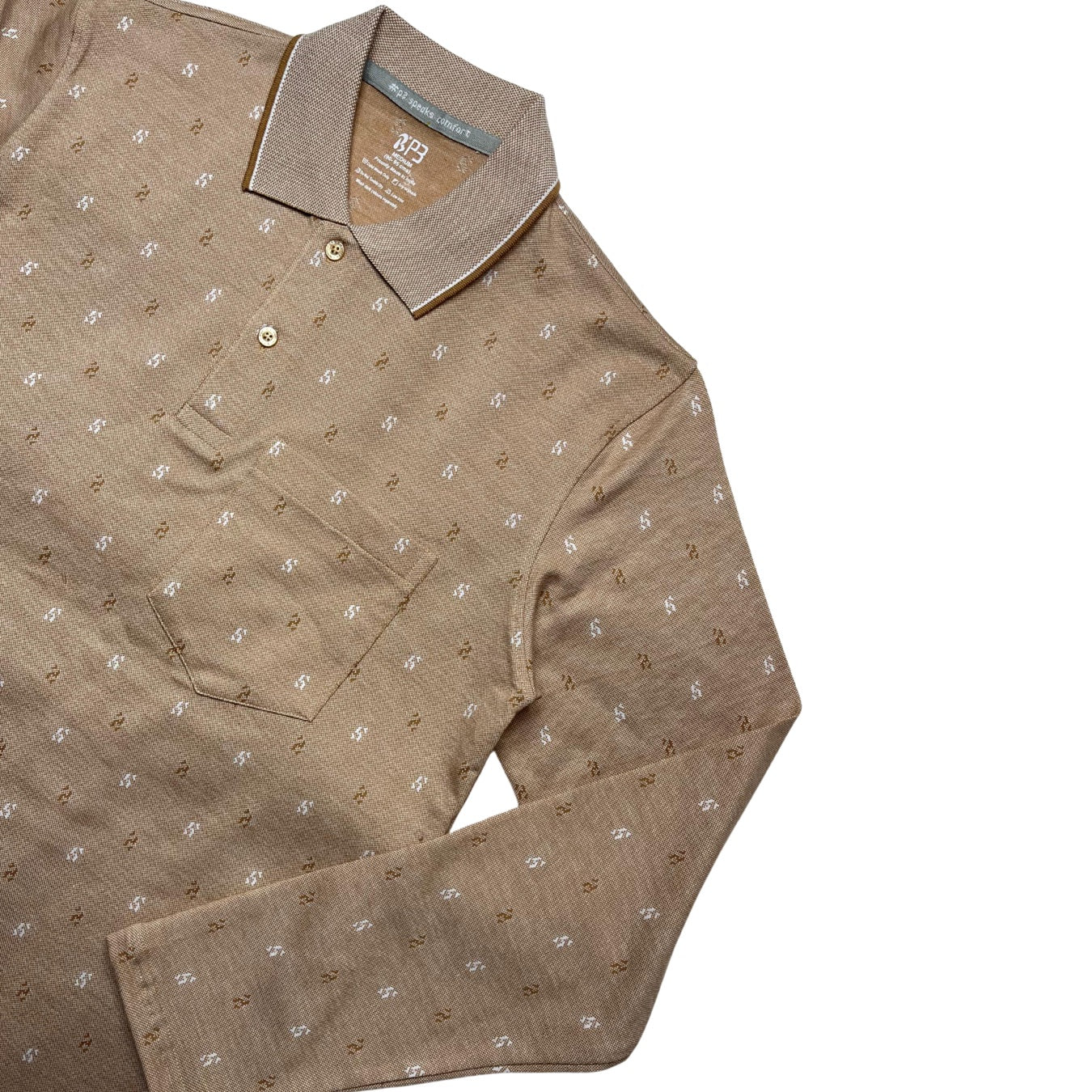 A green designer polo shirt with a pattern of small, white geometric shapes and a two-button placket.
